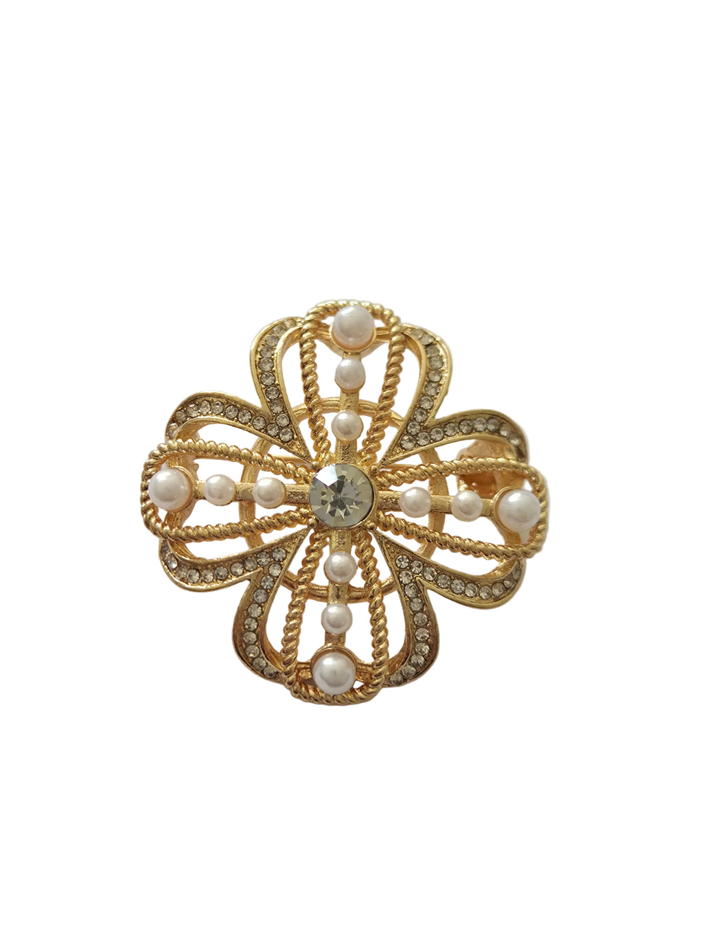 Pearl four-leaf clover brooch with central gemstone on a light gray background