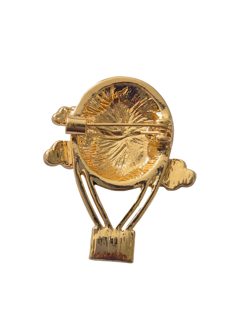 Gold hot air balloon brooch on a white background
