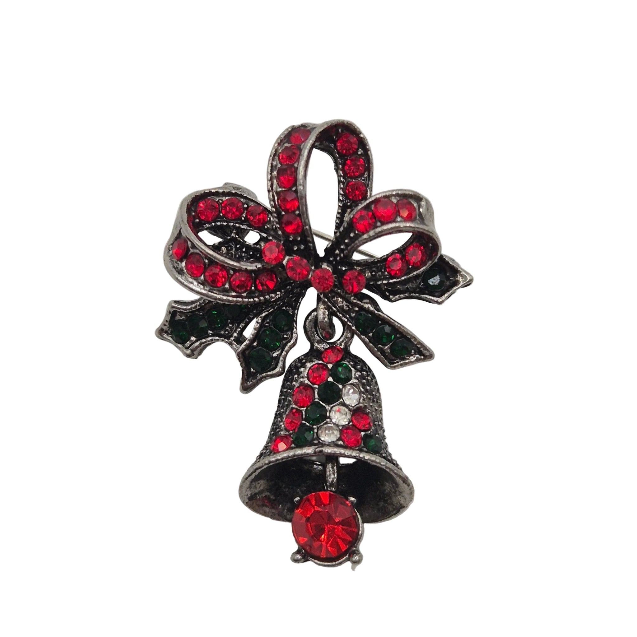 A Christmas-themed brooch featuring a silver-tone metal bow and bell design embellished with red and dark green rhinestones, set against a plain white background.