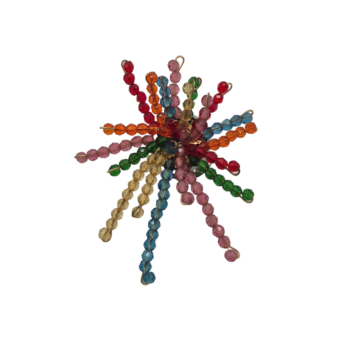 A small multicolor beaded firework burst brooch with radiating strands of faceted beads in red, orange, yellow, green, blue, pink, and purple, centered on a plain white background.