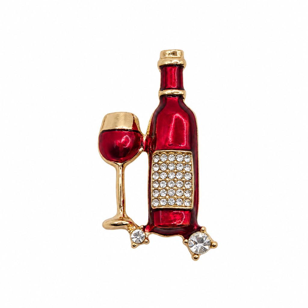 Red enamel wine bottle and glass brooch with gold-tone detailing and clear rhinestones, shown on a white background.