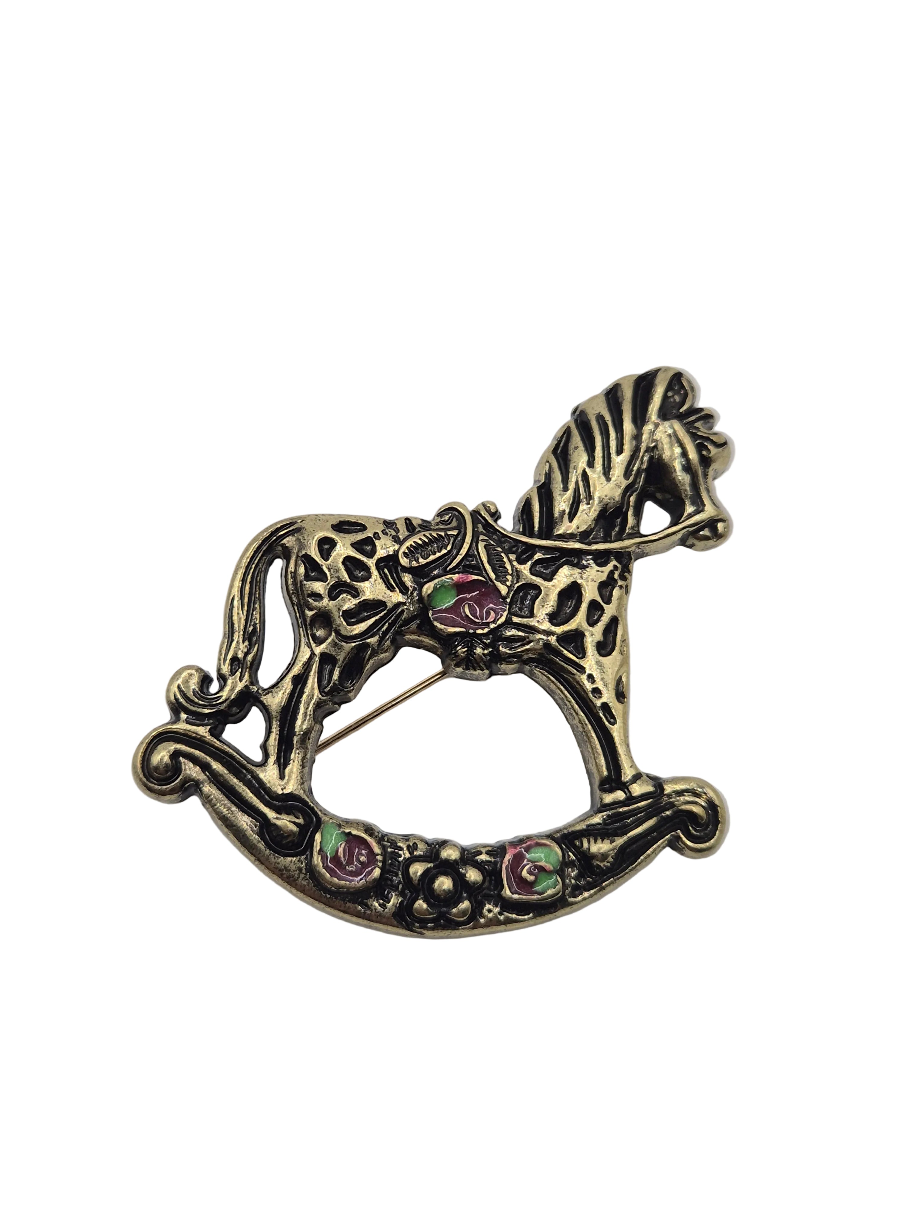 Gold rocking horse brooch  on white
