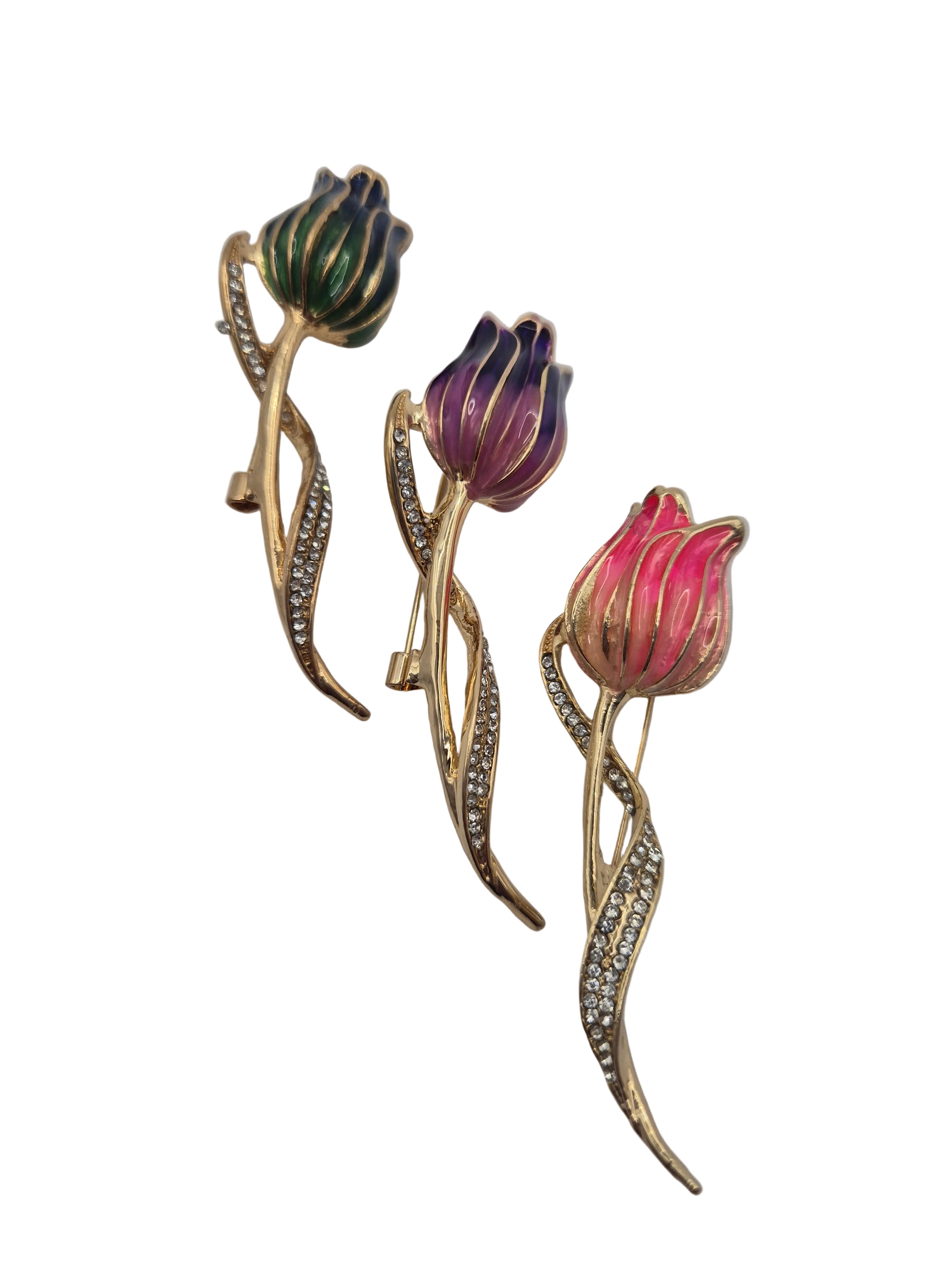 Three tulip-shaped brooches with gold and gemstone accents on a white background
