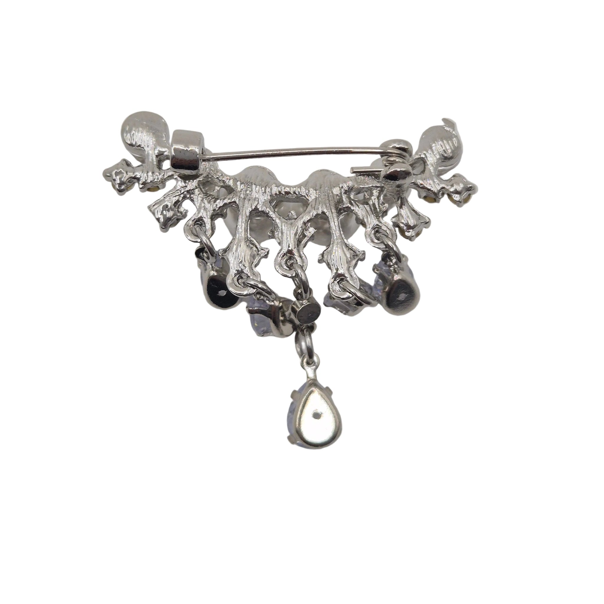 A silver-toned metal brooch featuring a decorative, organic branch-like top with dangling black beads and a teardrop-shaped silver charm, shown on a plain white background.
