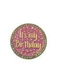 Pink and gold round badge with 'It's my Birthday' text on a gray background