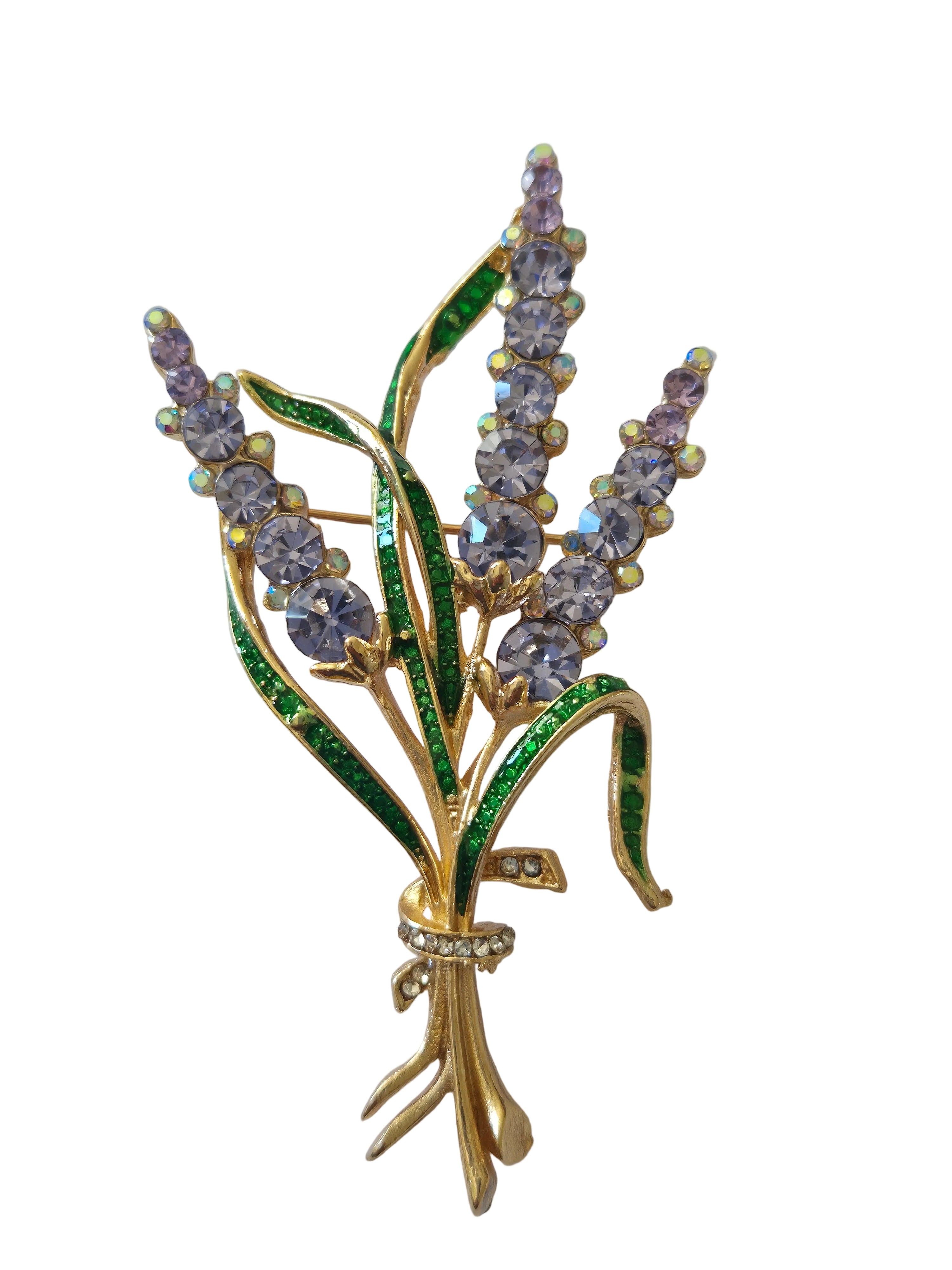Gold brooch with purple and green gemstones on a light gray background