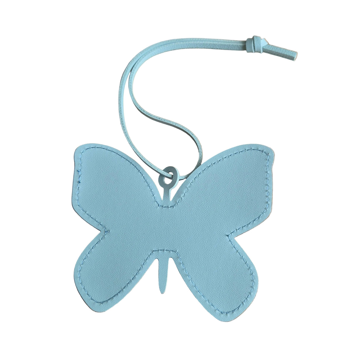 A light blue faux-leather butterfly-shaped bag charm with a matching loop strap, placed on a plain white background.