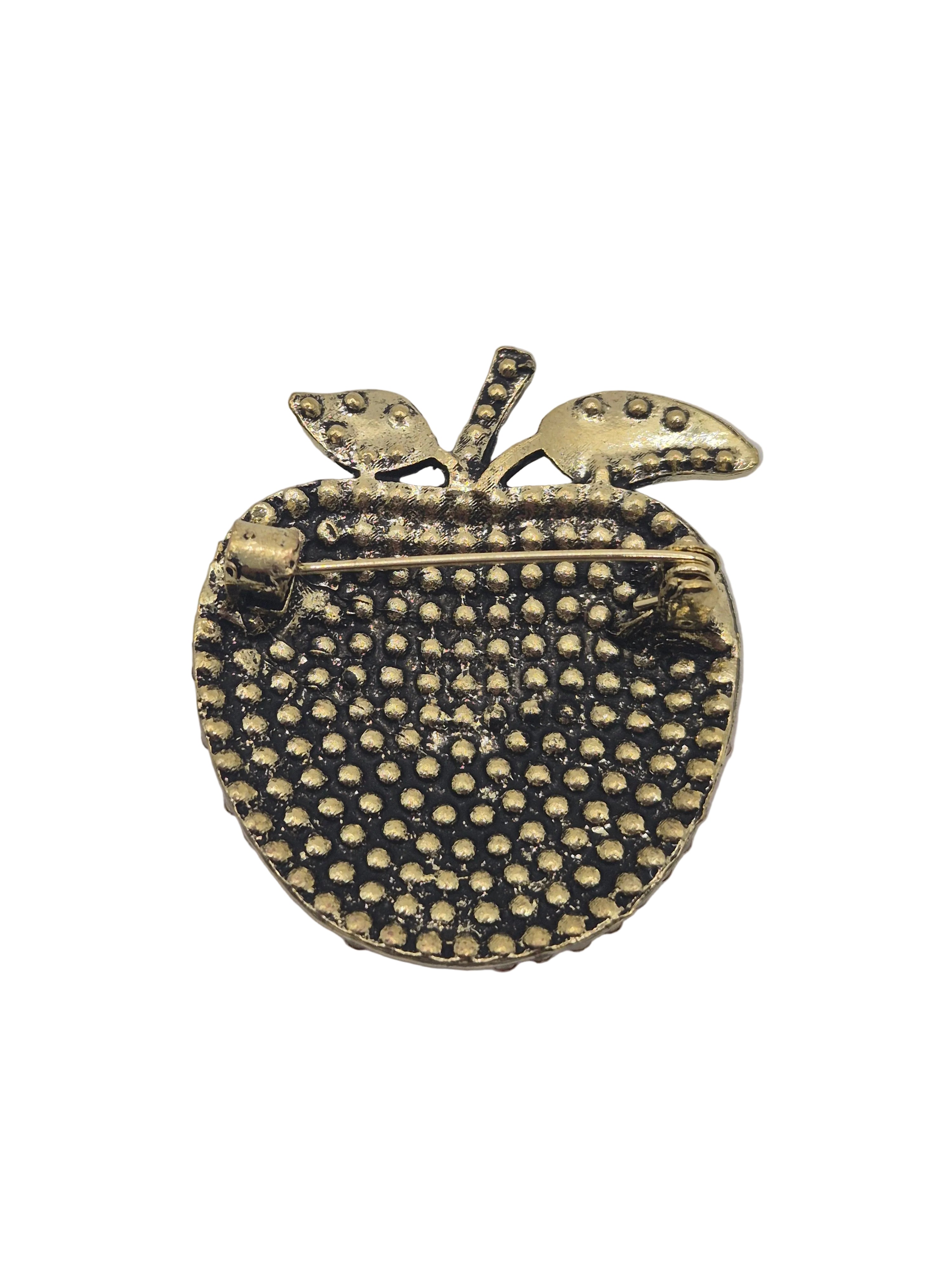 red apple-shaped brooch with textured surface on a white background