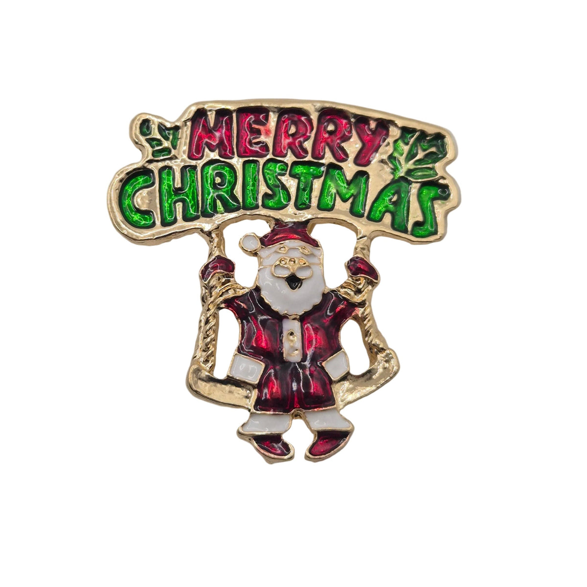 A Christmas-themed enamel pin featuring a gold-tone Santa Claus with a banner that reads 'MERRY CHRISTMAS' in green and red lettering, set against a plain white background. 