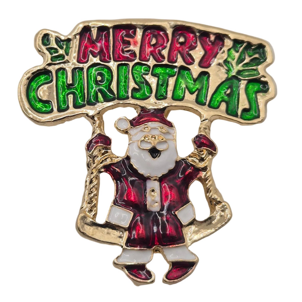 A festive Christmas enamel pin featuring a gold-tone Santa Claus and a banner that reads 'MERRY CHRISTMAS' in green and red lettering, set against a plain white background.