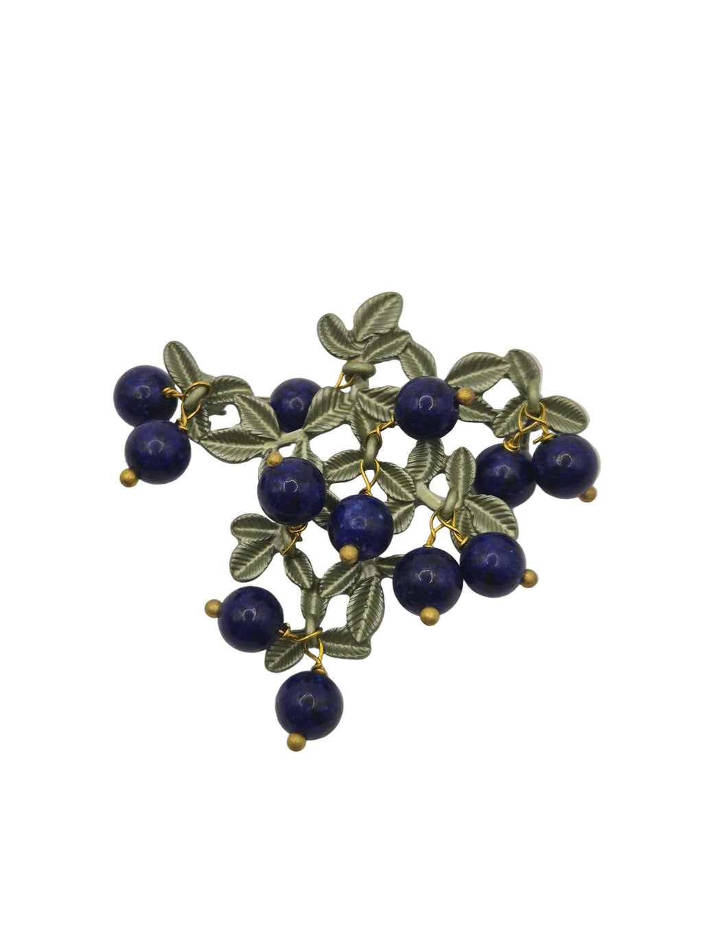 Brooch with blue berries and green leaves on a white background