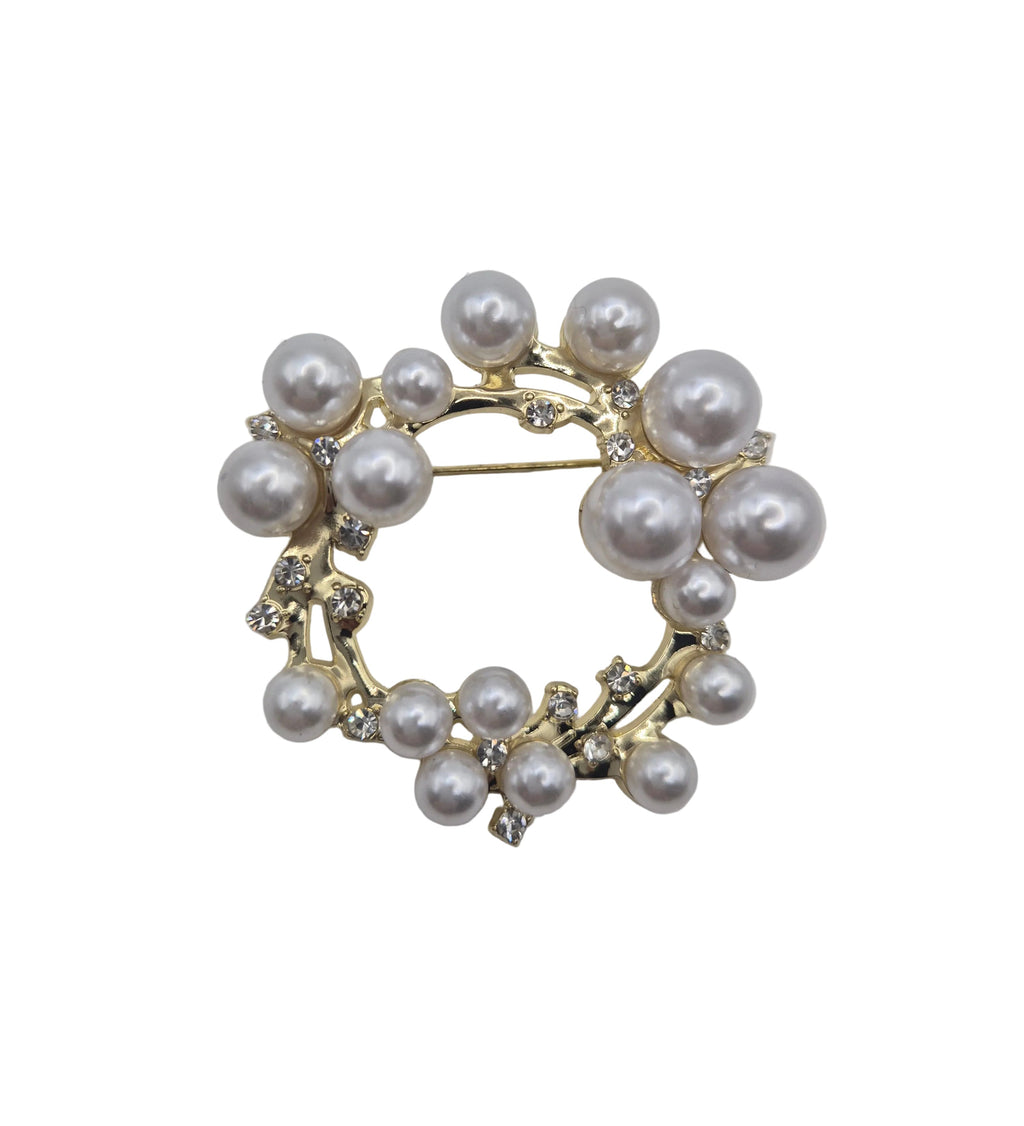 Pearl wreath brooch on a light gray background