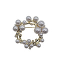 Pearl wreath brooch on a light gray background
