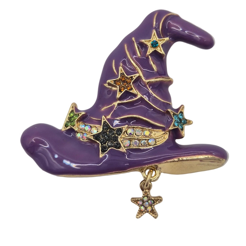 A purple witch hat brooch with gold-tone metal trim, decorated with gold star accents and rhinestone details, featuring a dangling gold star charm on a white background.