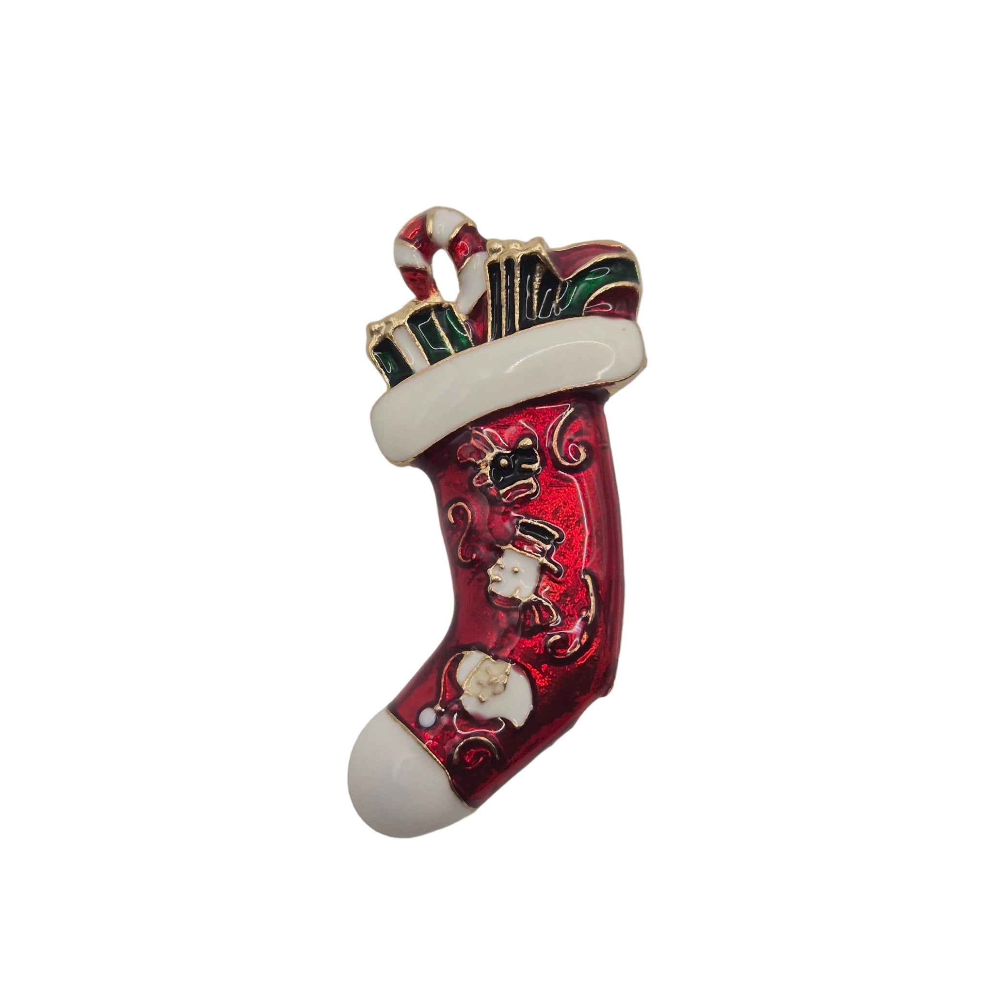 A Christmas stocking-shaped brooch or charm with a red body, white cuff and toe, and small Santa and candy cane details, photographed on a plain white background.