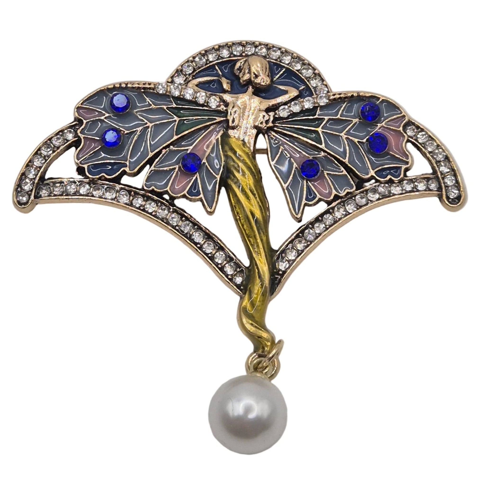 An Art Deco style brooch featuring a winged fairy figure with blue and gold enamel details, set with clear rhinestones and hanging from a white pearl drop, shown on a plain white background.