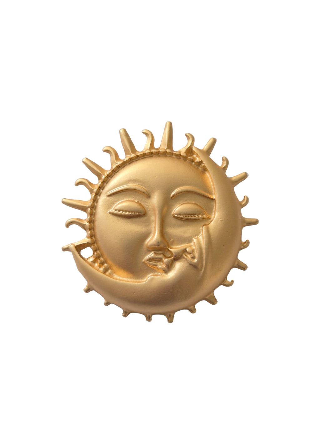 Gold sun and moon face brooch on a white background