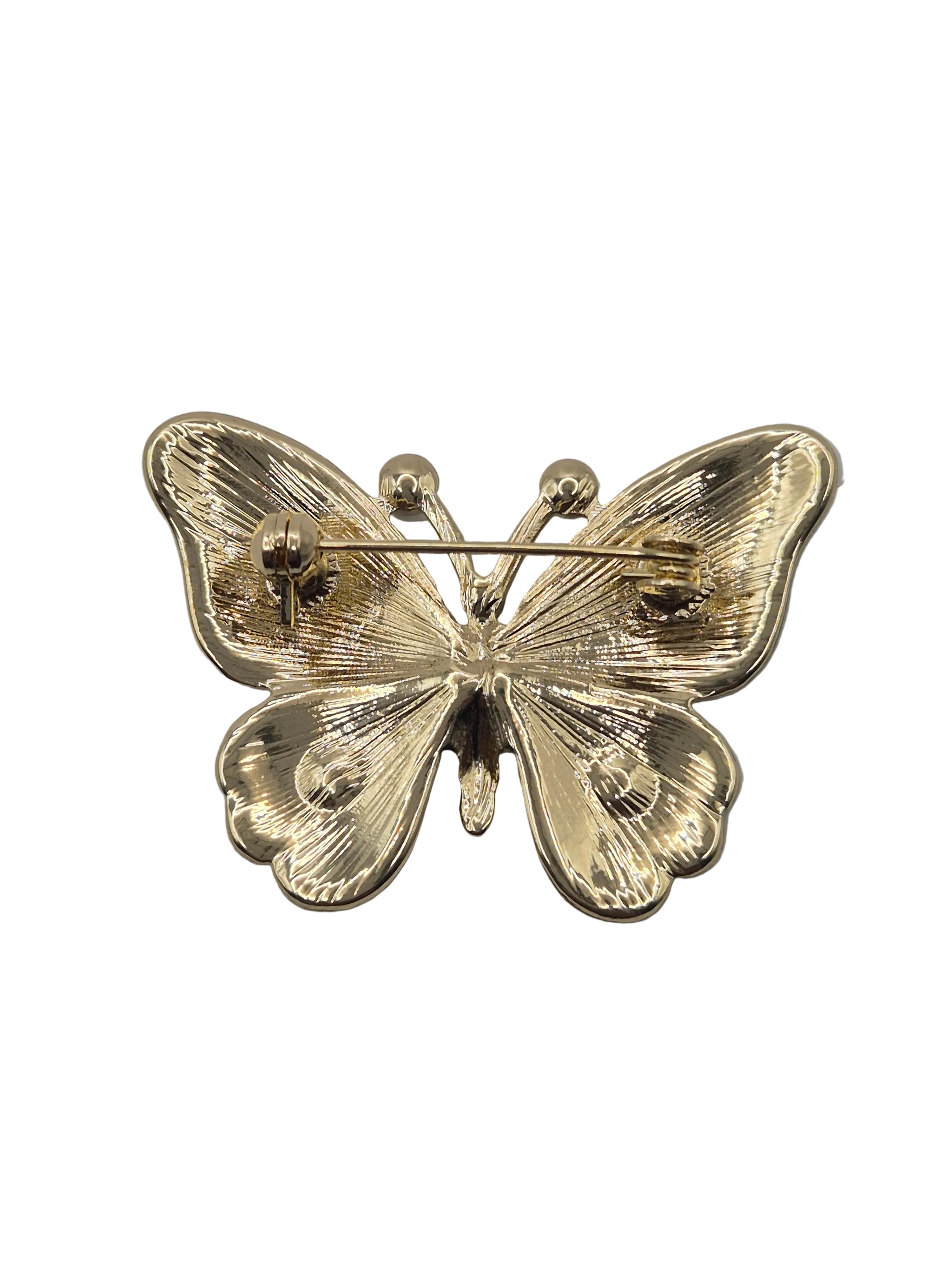 butterfly brooch on a white background floral detail