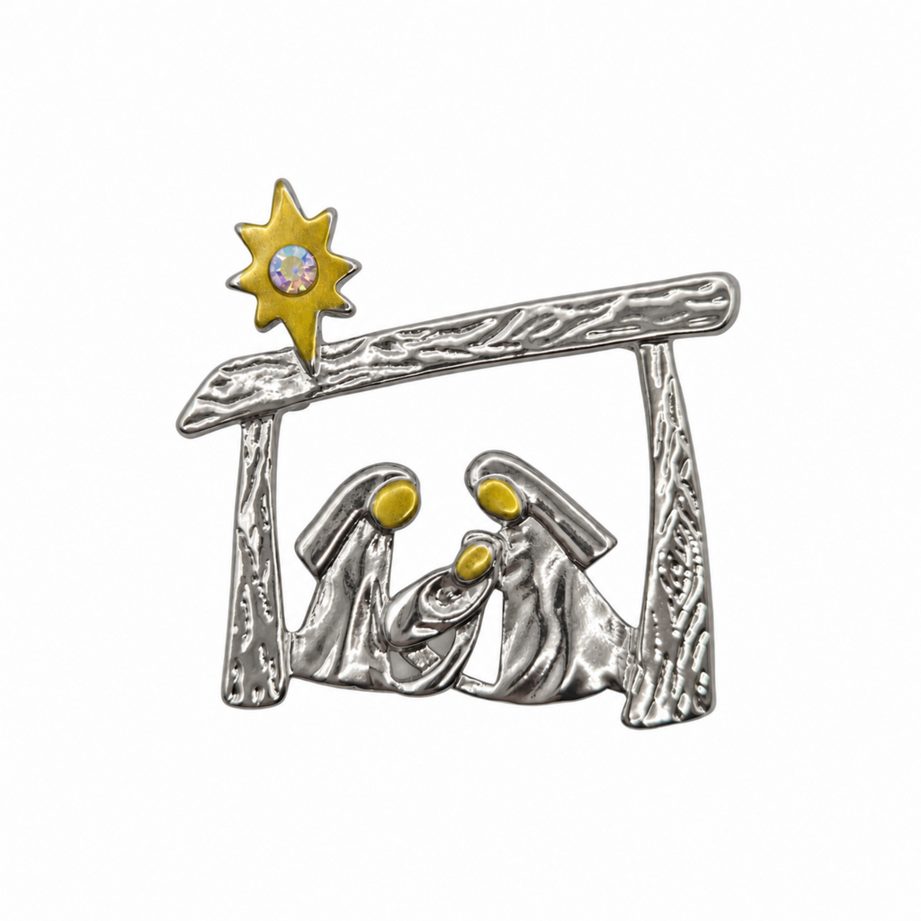 A silver-toned metal nativity scene  brooch pin featuring Mary, Joseph, baby Jesus, and a gold star with a clear rhinestone, shown on a plain white background.