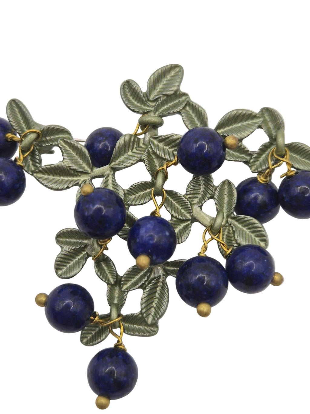 blueberry brooch with blue beads and green leafy patterns on a white background