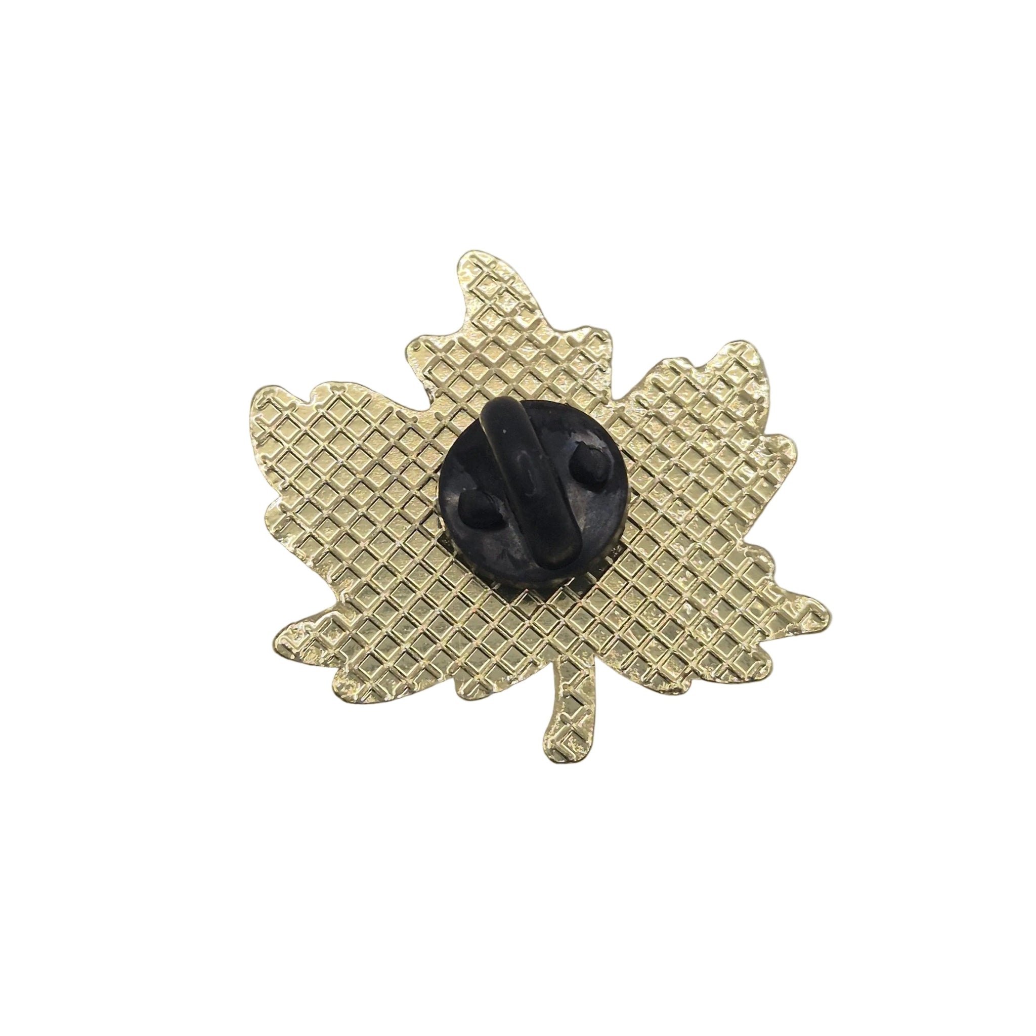 A gold maple leaf-shaped brooch with a textured grid pattern and a central black oval stone, shown on a plain white background.