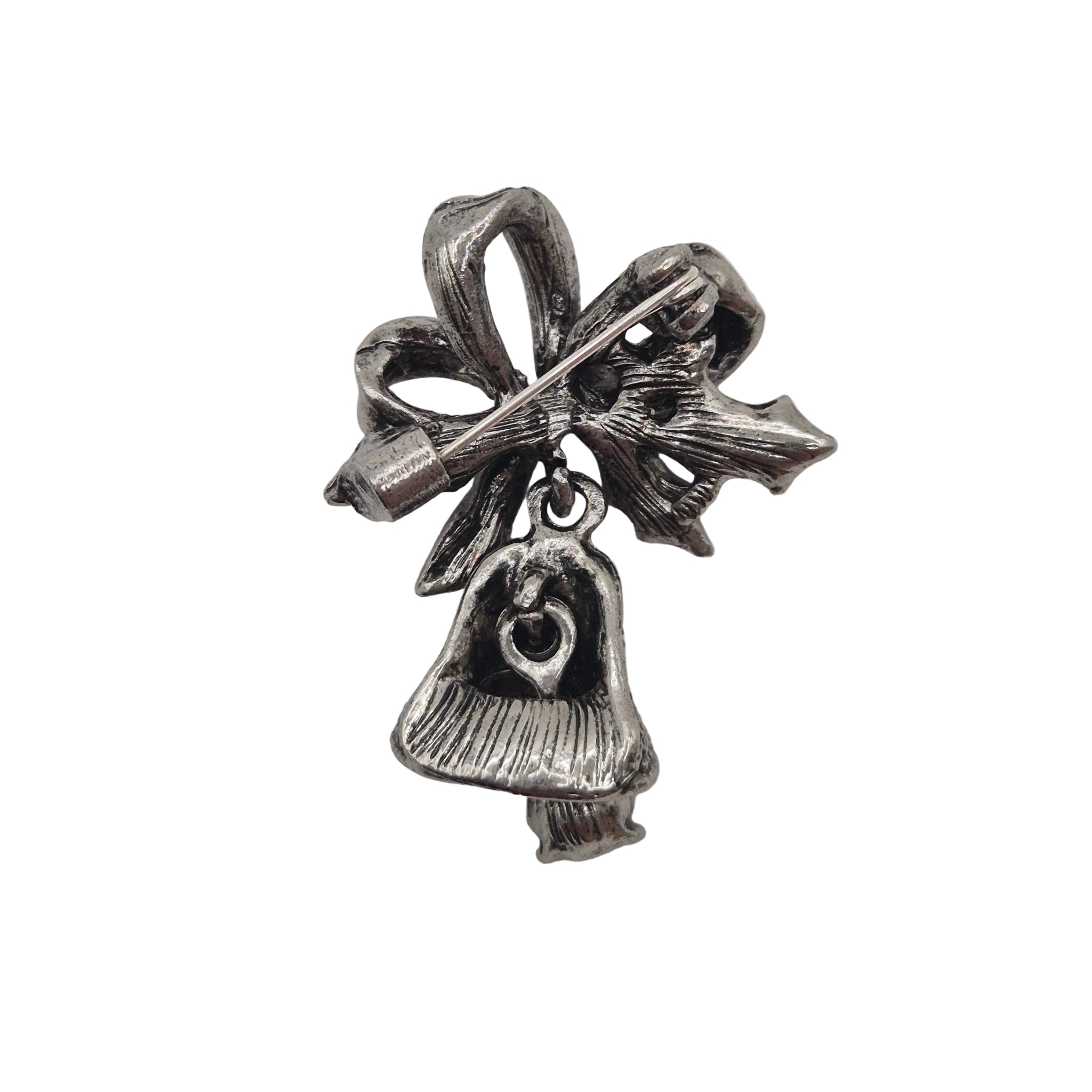 A silver-toned Christmas ornament charm featuring a bow, star, and bell with a heart detail, shown on a plain white background.