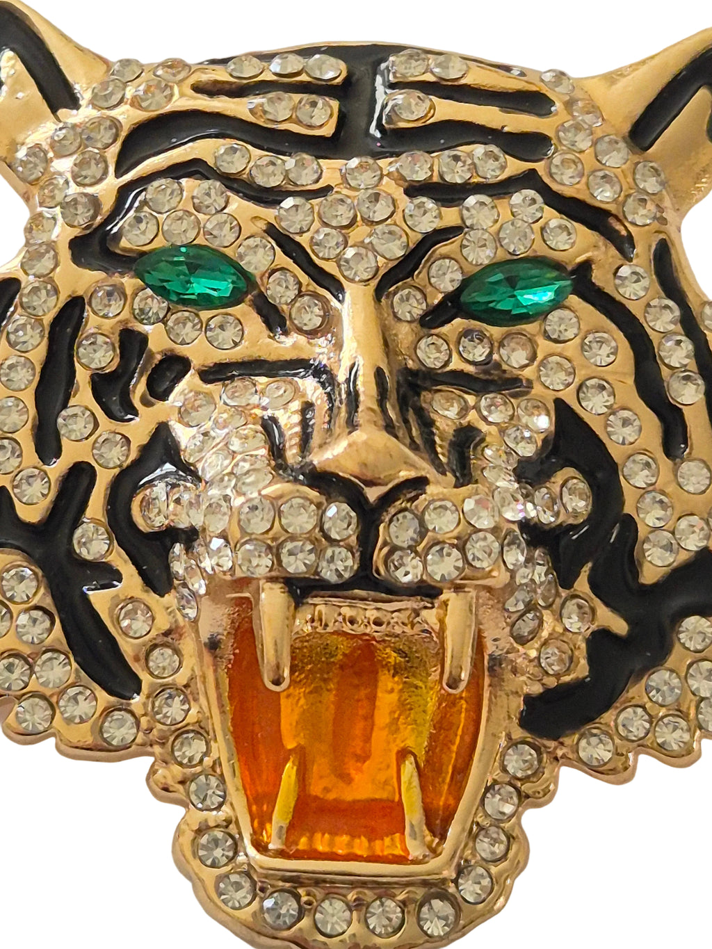 Decorative tiger brooch with gold, black, and gemstone details on a white background