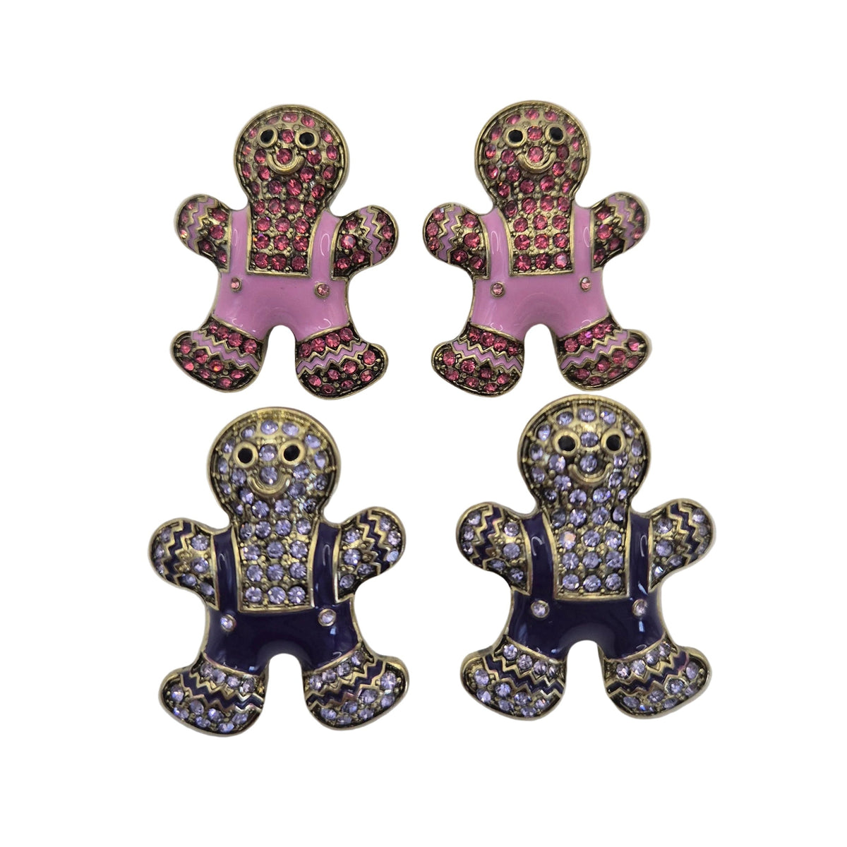 Four gingerbread person stud earrings arranged in a 2x2 grid on a white background. The top pair features pink overalls with gold and silver rhinestone detailing, and the bottom pair features dark purple overalls with matching rhinestone detailing.