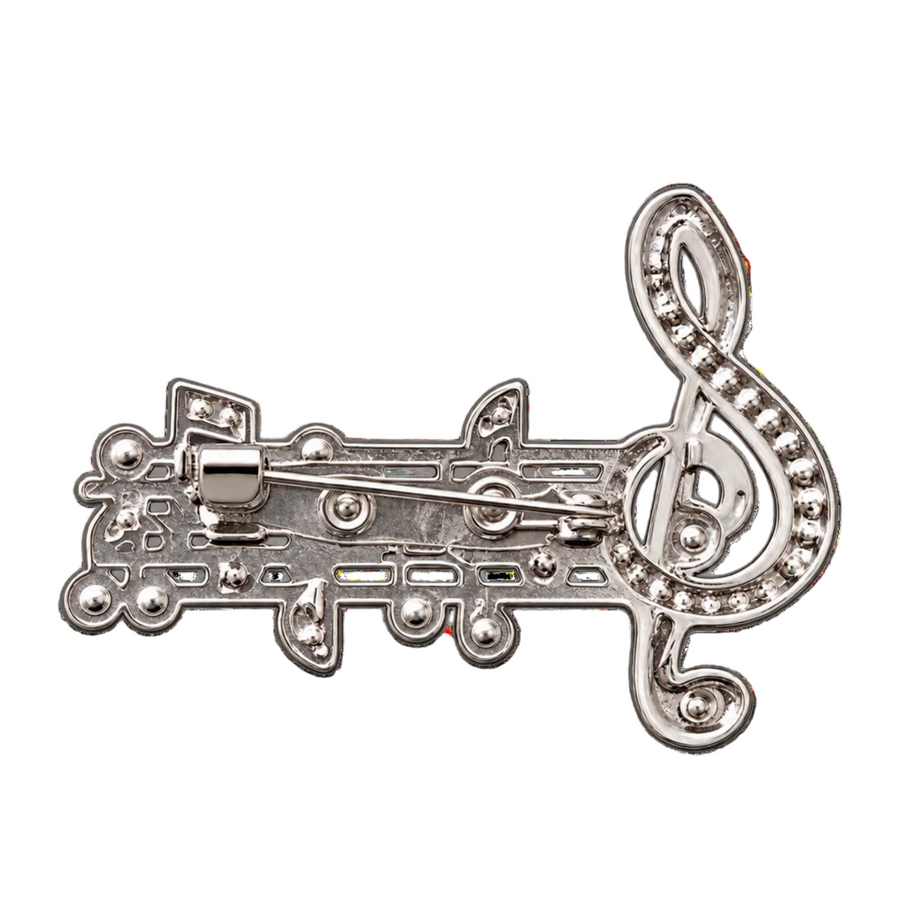 A silver-tone metal lapel pin shaped like a musical staff with a treble clef, featuring small clear rhinestone accents, shown on a plain white background.