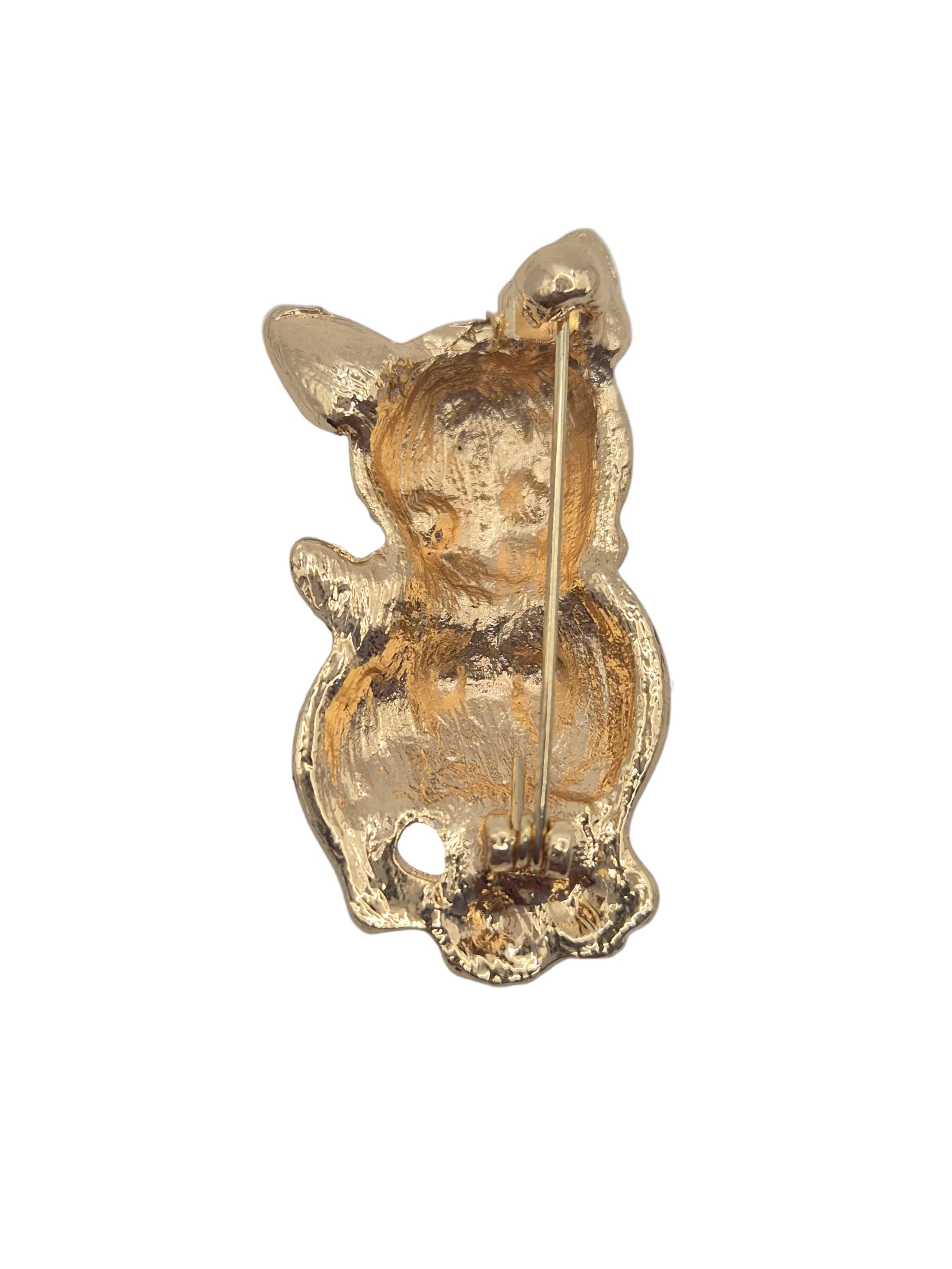 Reverse gold tone side of kitten brooch shown against a plain white background.