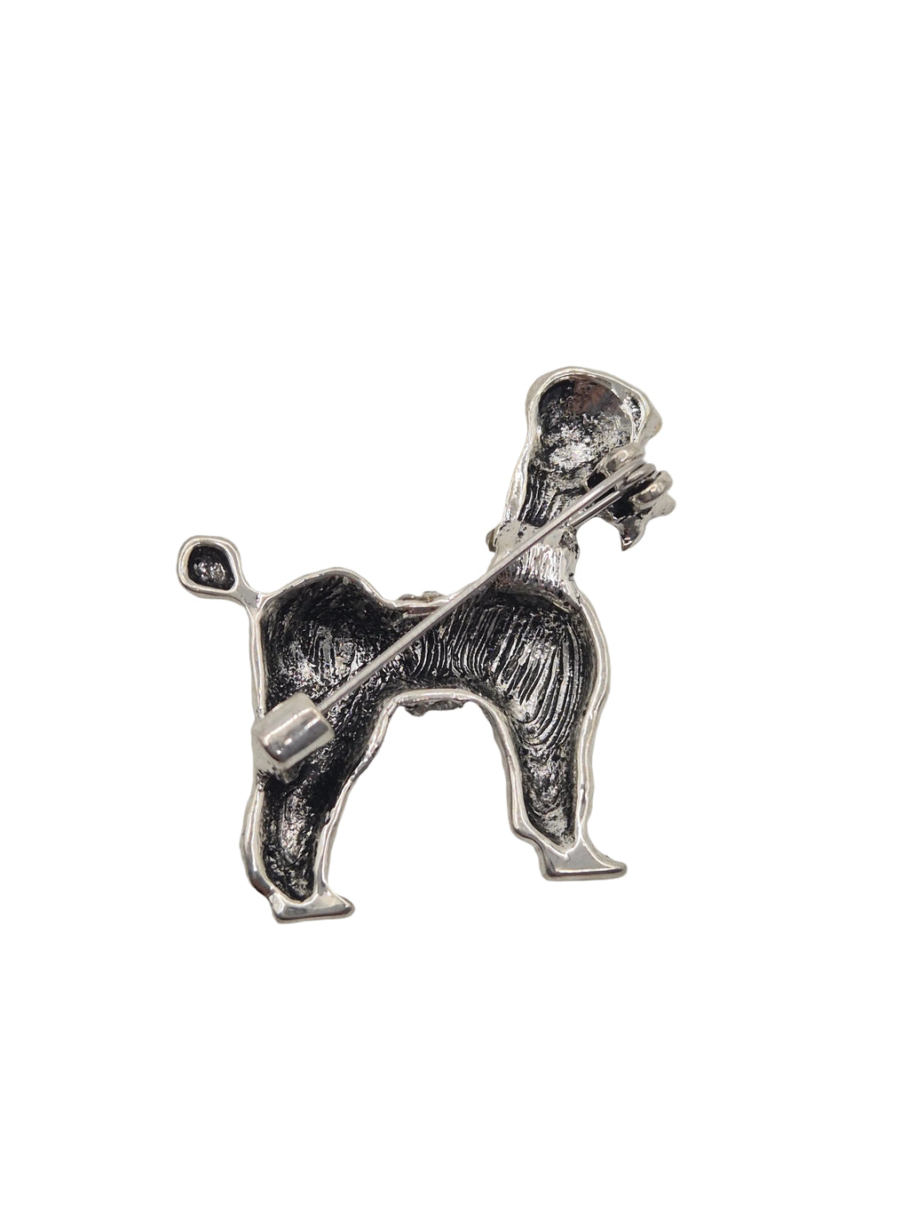 A silver-tone metal dog-shaped brooch or pin, shown in profile against a plain white background.