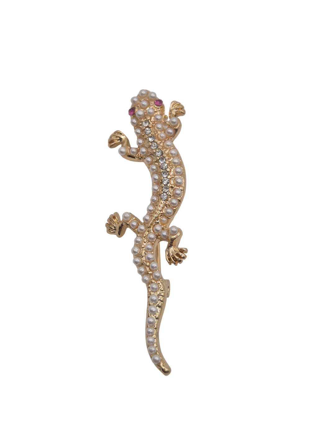 A gold gecko or lizard-shaped brooch embellished with small white pearls and clear rhinestones, featuring tiny red gemstone eyes, shown against a plain white background.