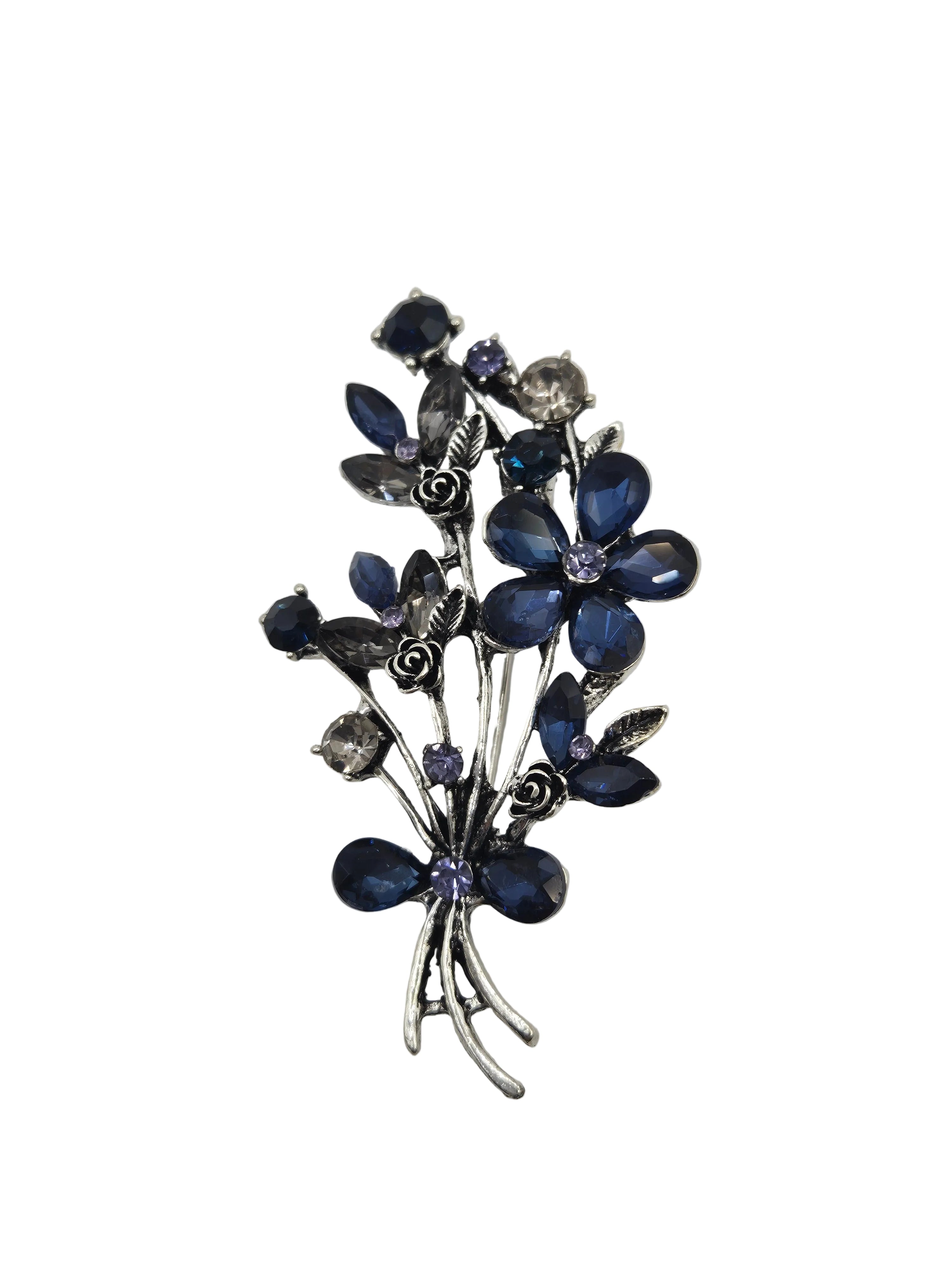 Decorative brooch with blue floral elements on a gray background