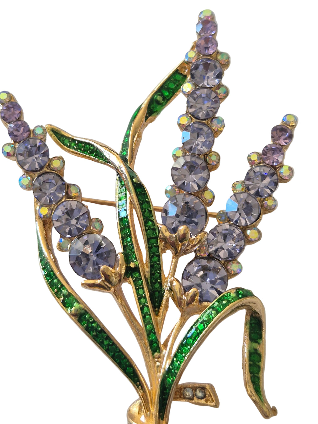 "Large floral brooch with lavender flowers and green leaves on a white background"
