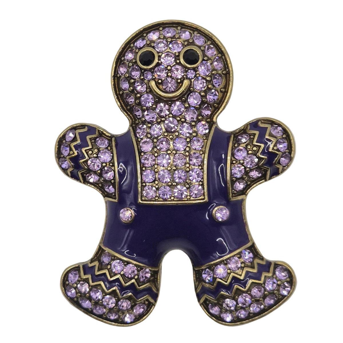 A gingerbread person-shaped brooch or pin featuring a dark purple enamel body, light purple rhinestone embellishments, and gold-tone metal outlines, shown on a plain white background.