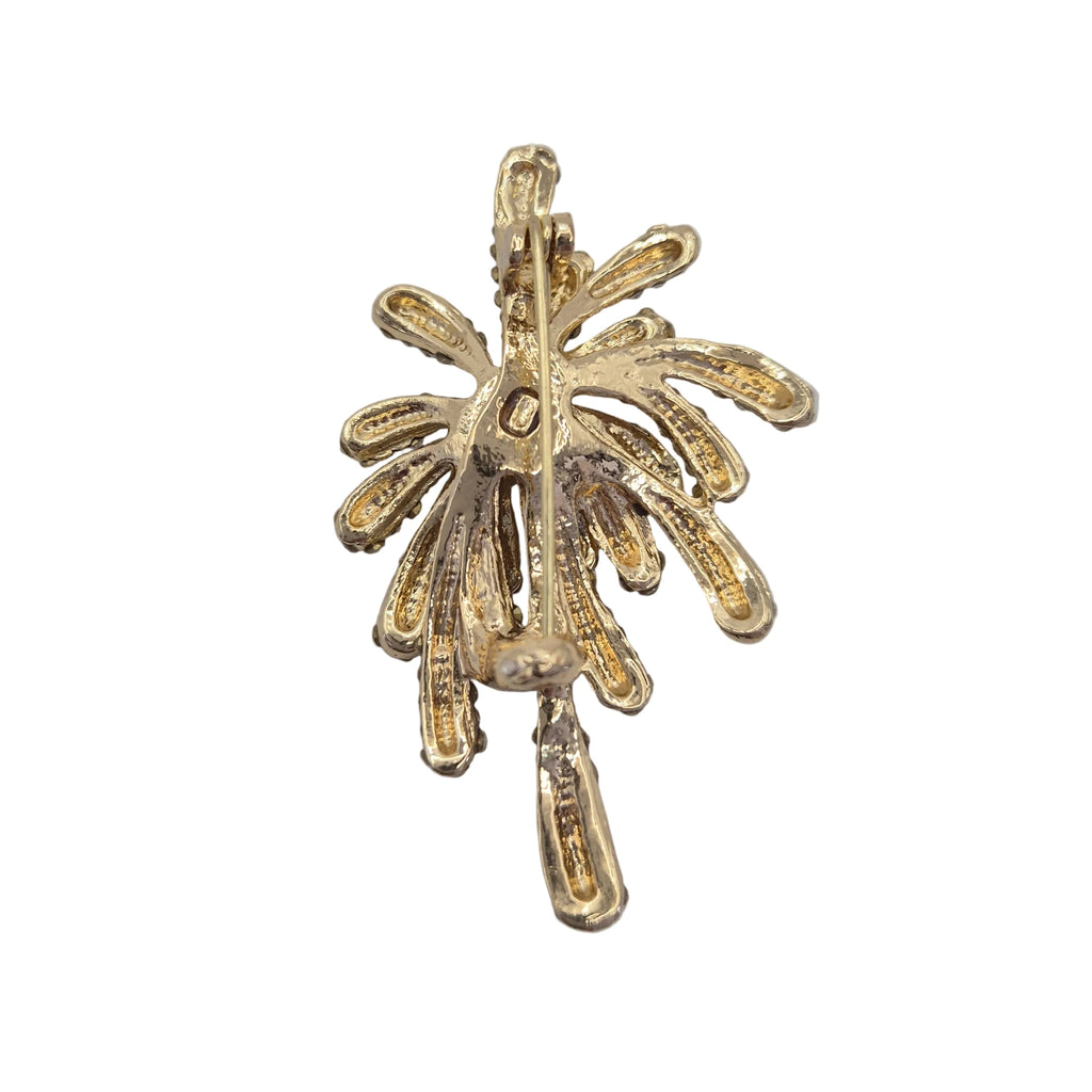 Gold firework brooch pin shown on reverse side, displayed against a plain white background.