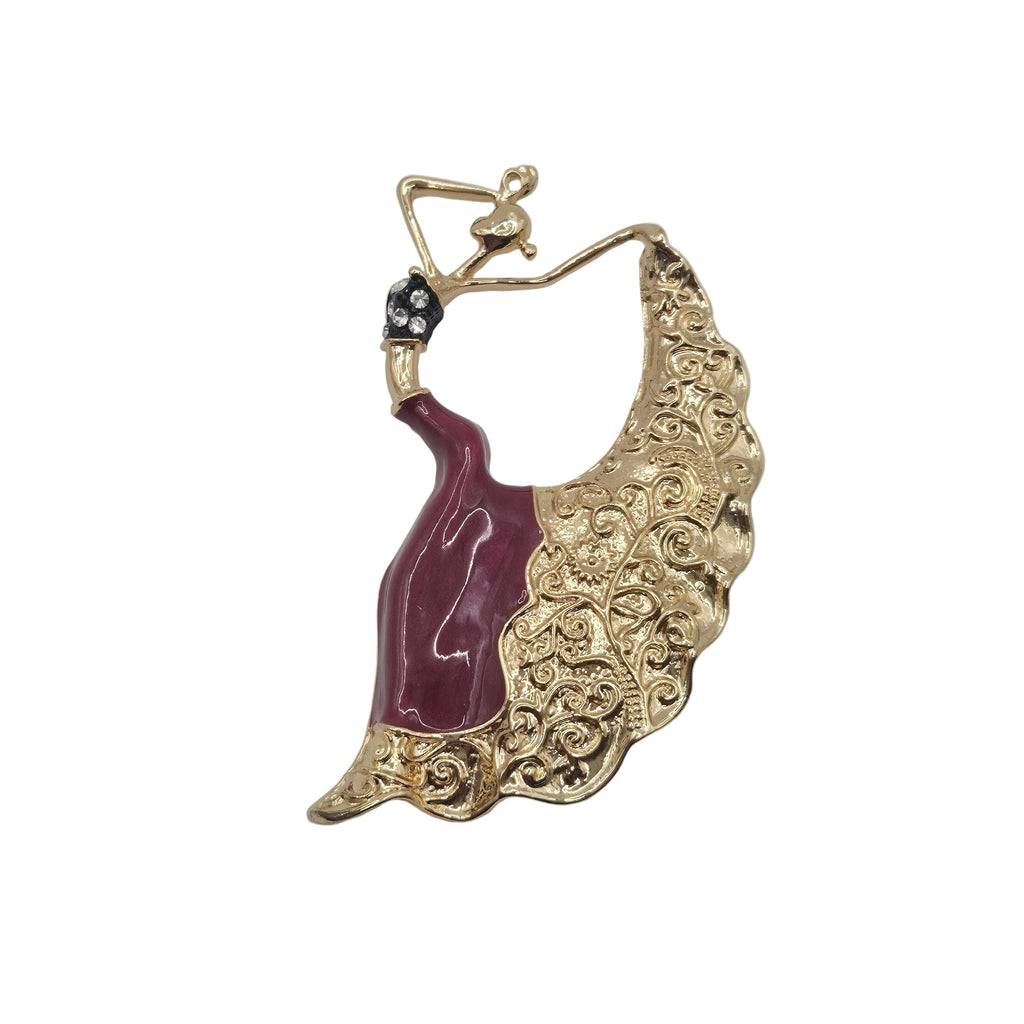 Gold-tone dancing woman brooch with burgundy enamel dress, ornate flowing skirt and sparkling rhinestone detail. Shown against a plain white background.