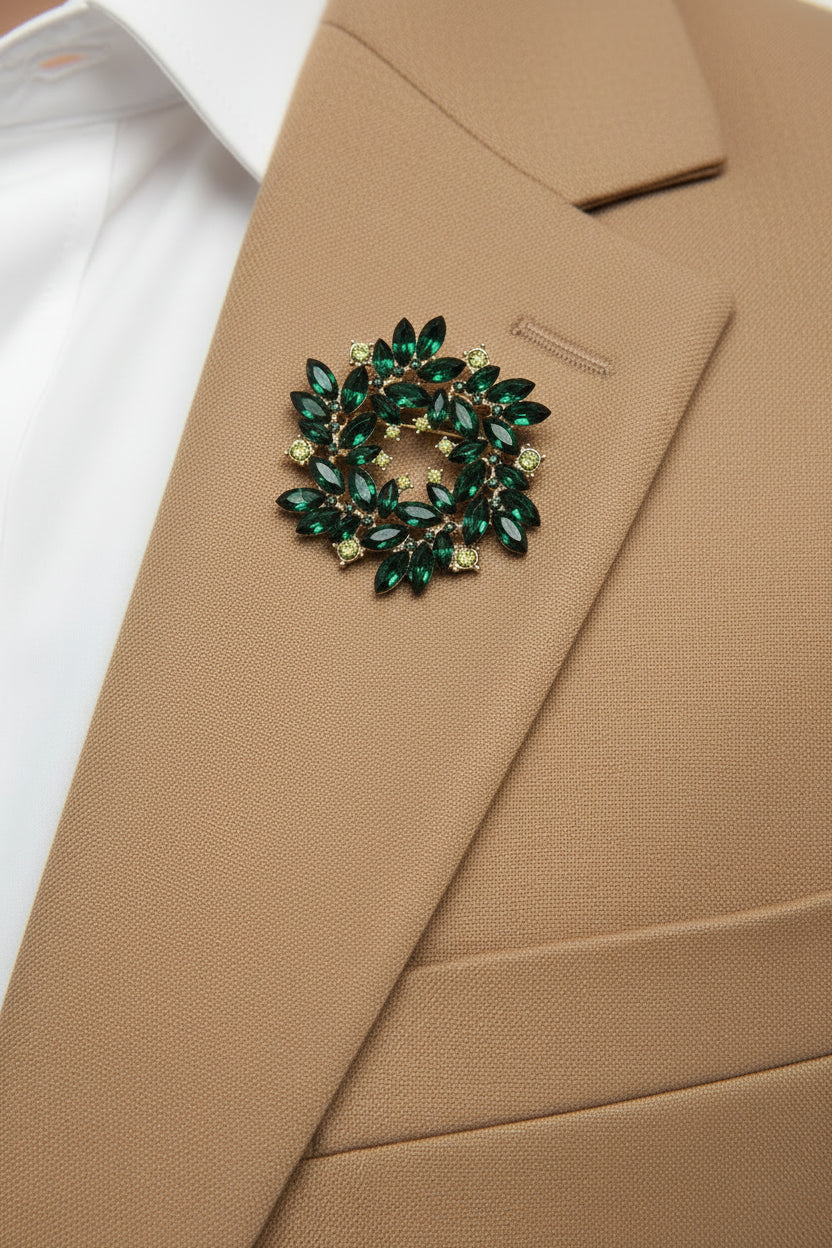 Green gemstone brooch on a gray background