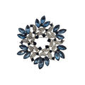 Blue and silver wreath brooch on white background