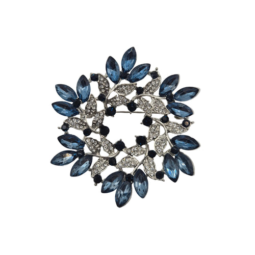 Blue and silver wreath brooch on white background