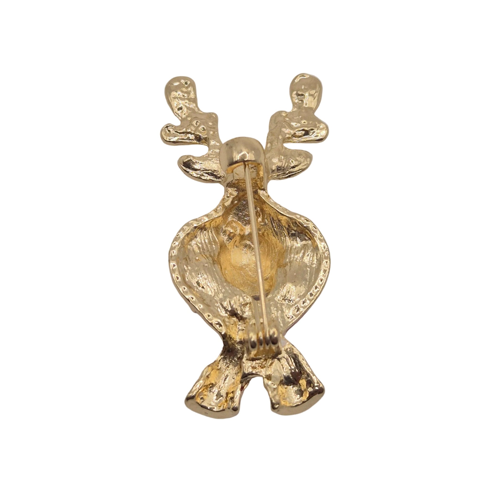 A gold-coloured reindeer-shaped pin or brooch with a textured finish and a visible metal pin mechanism on the back, photographed against a plain white background.