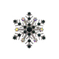 A snowflake-shaped brooch featuring dark green faceted gemstones, a central dark green stone, and iridescent clear rhinestones on a silver-toned setting, shown on a plain white background.