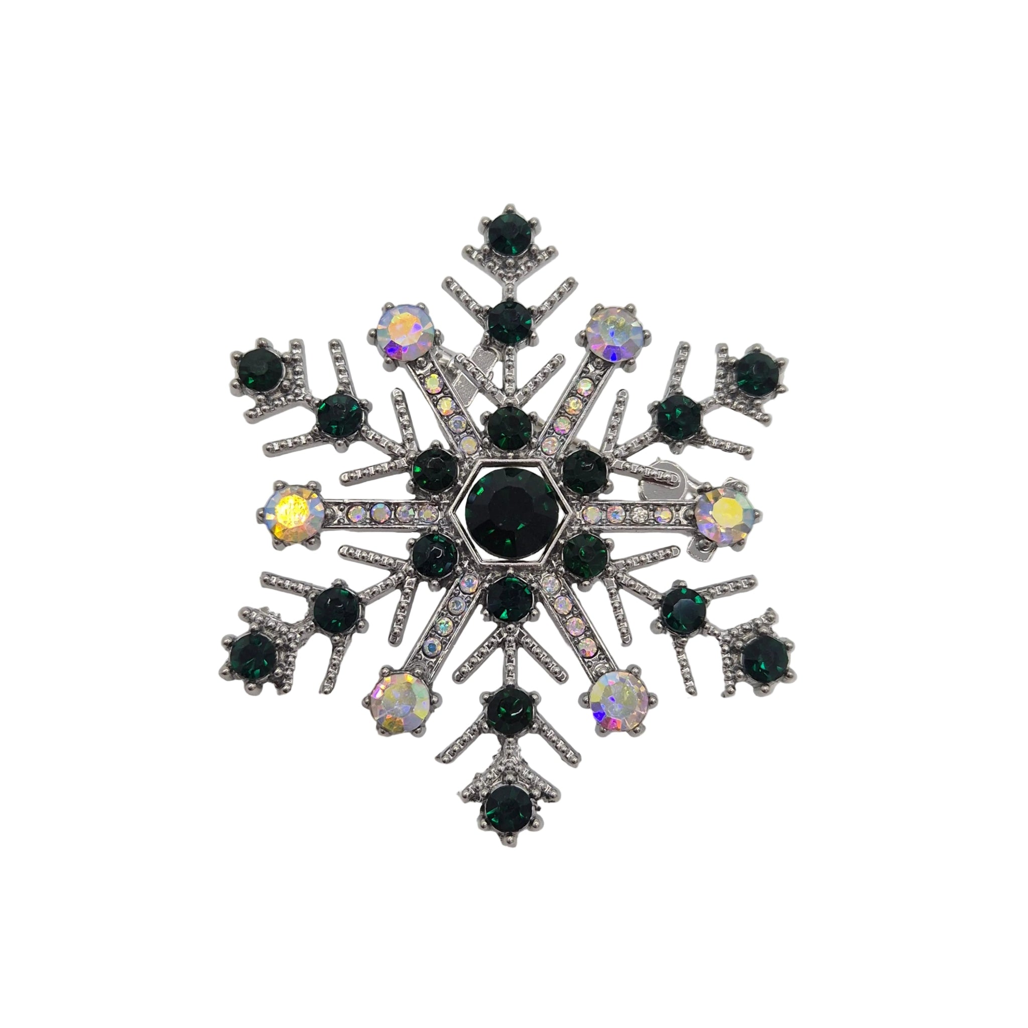 A snowflake-shaped brooch featuring dark green faceted gemstones, a central dark green stone, and iridescent clear rhinestones on a silver-toned setting, shown on a plain white background.