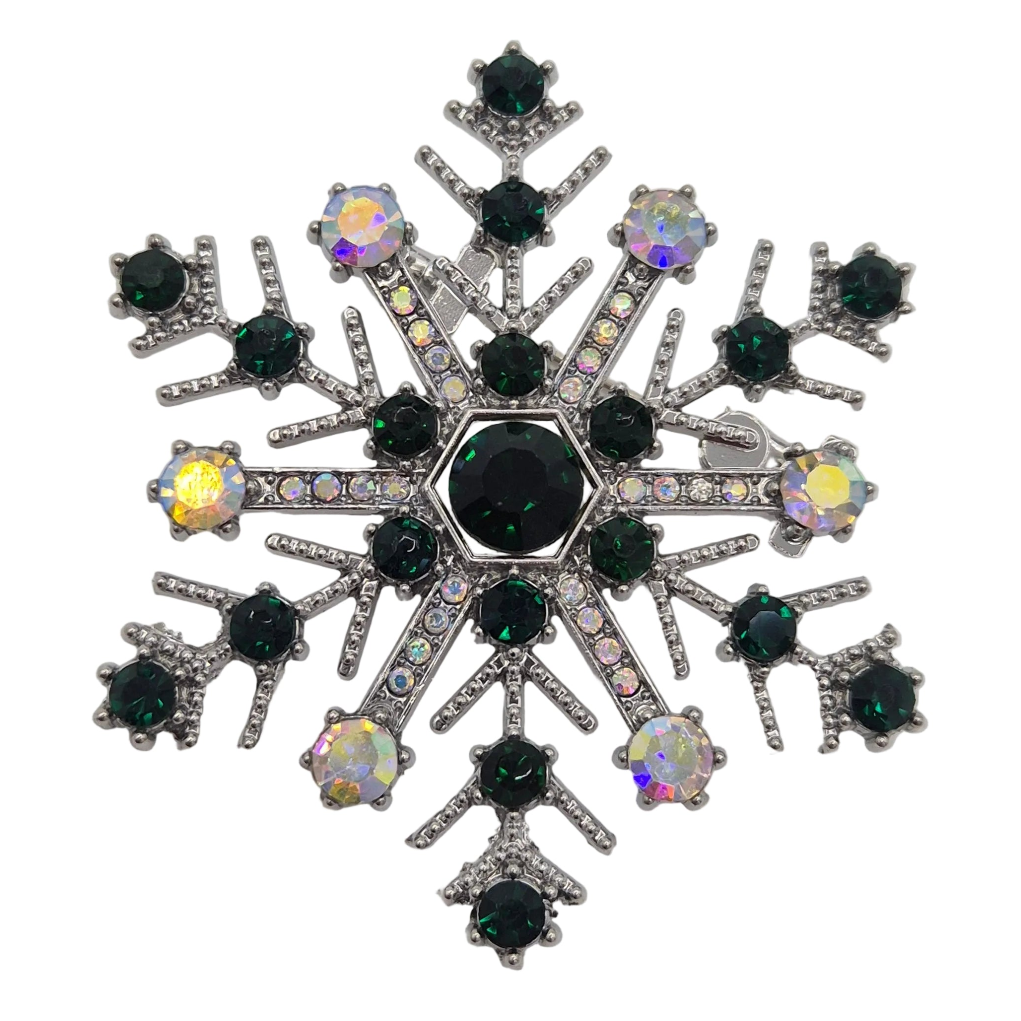 A snowflake-shaped brooch featuring a central black round crystal surrounded by smaller dark green and iridescent faceted crystals, set in a silver-toned metal.