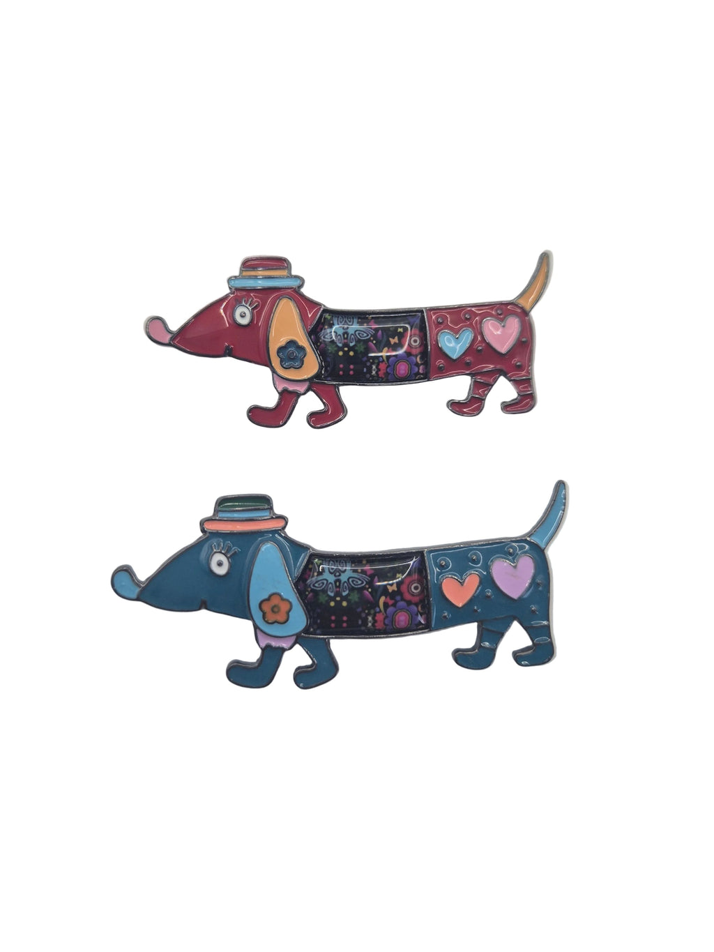 Two colorful brooches shaped like dachshund dogs, one in red and burgundy with a pink hat, and the other in blue and teal with a dark hat, both decorated with hearts and stars, on a plain white background.