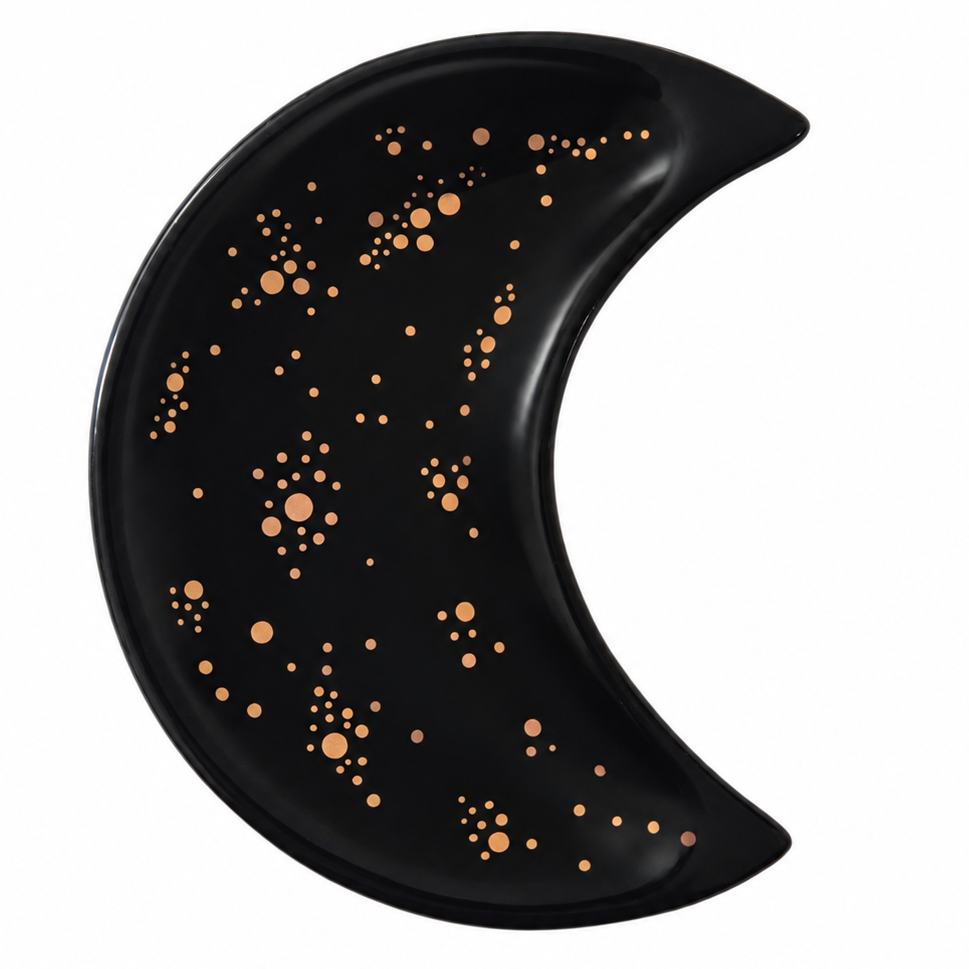A crescent moon-shaped black tray decorated with metallic rose gold star patterns, shown on a solid white background.