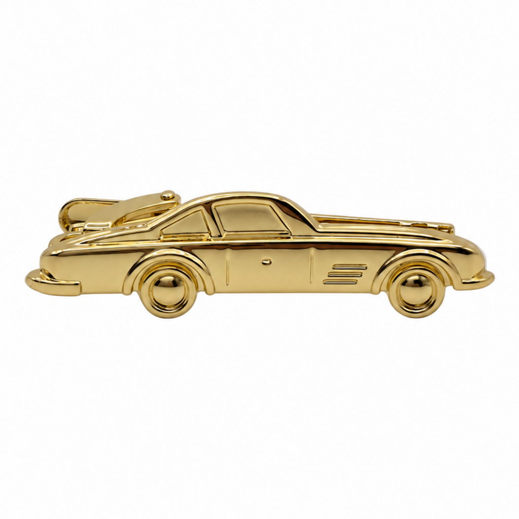 A shiny gold car-shaped brooch or pin shown in side profile on a plain white background.