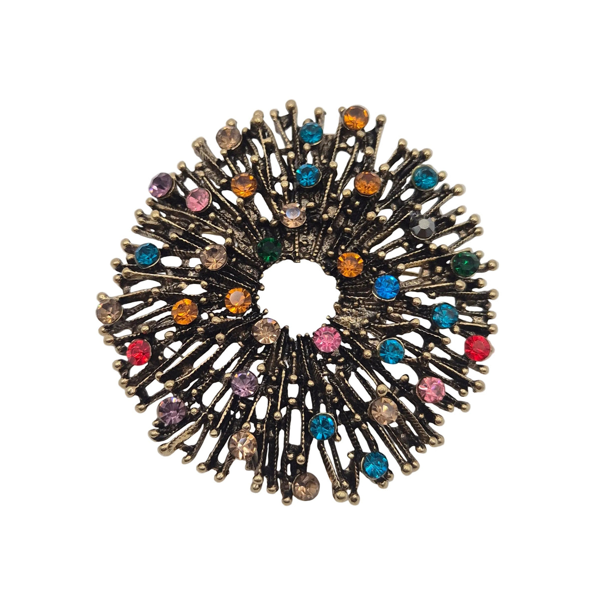A circular firework brooch featuring a antique gold metal base with multiple radiating spikes adorned with small, colourful rhinestones in pink, blue, orange, green, and purple, set against a plain white background.