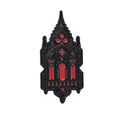 A gothic cathedral-shaped enamel pin with a black metal outline and vibrant red enamel details, shown on a plain white background.