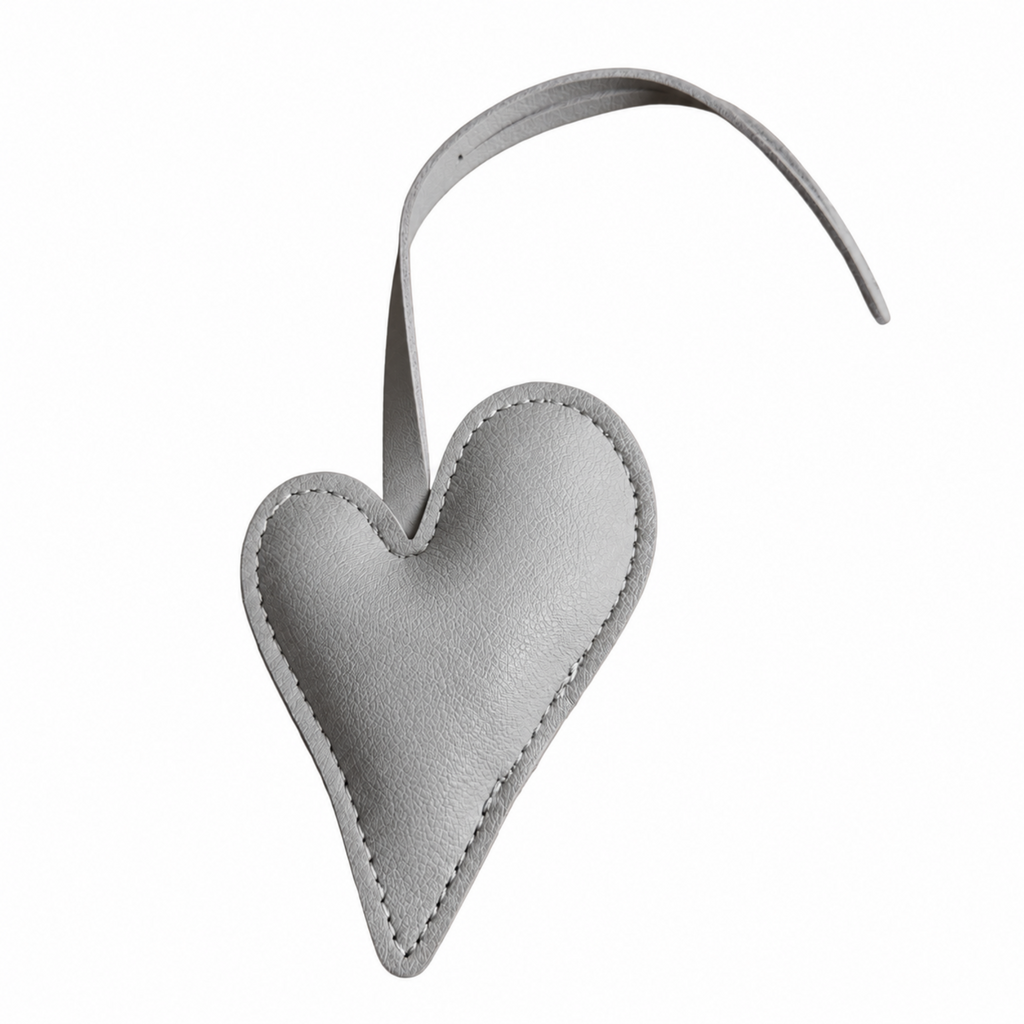 A light gray textured leather heart-shaped bag charm with a matching curved strap, shown on a plain white background.